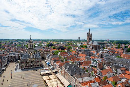 Delft panoramic city view with the city Hall at the Market in Delft seen from above from the tower of the New Church during a summer day in the city in South Holland, The Netherlands.