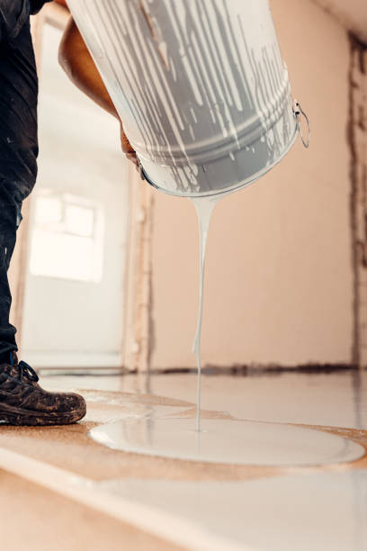 istock A construction worker applying grey epoxy resin in an industrial hall 1427523556