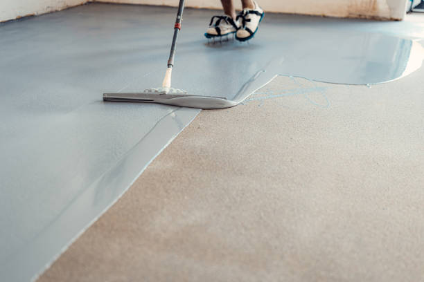 istock A construction worker applying grey epoxy resin in an industrial hall 1427524108