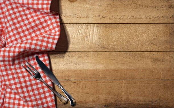 istock Empty Wooden Rustic Table with Checkered Tablecloth and Cutlery 1427524168