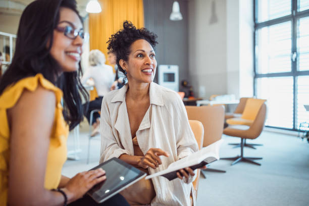 istock Two women meeting in the library 1427524288