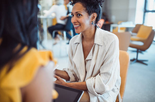 istock Two women meeting in the library 1427524289