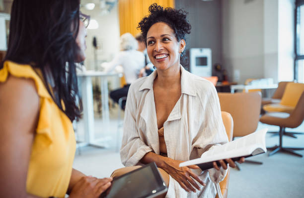 istock Two women meeting in the library 1427524293