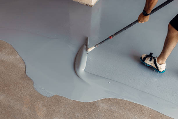 istock A construction worker apply grey epoxy resin in an industrial hall 1427525579