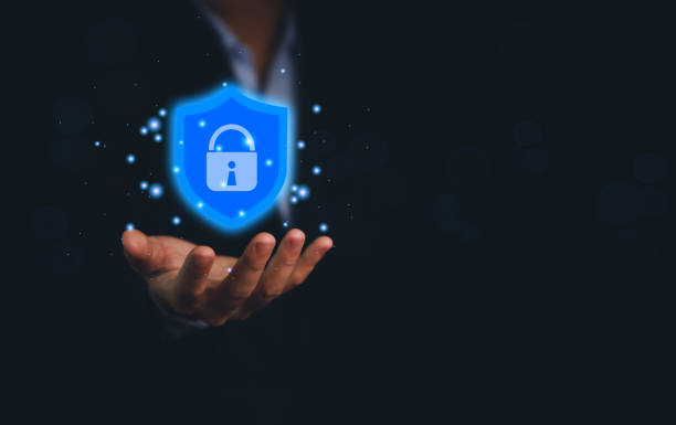 istock Businessman holding a shield icon with a lock mark. computer data password protection concept internet network security Cyber ​​digital technology. Business data and virus protection 1427526346