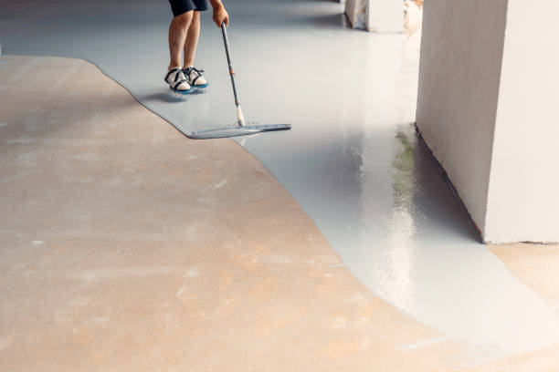 istock A construction worker applying grey epoxy resin in an industrial hall 1427526766