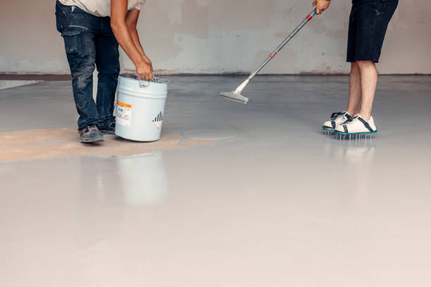 istock A construction worker apply grey epoxy resin in an industrial hall 1427527273
