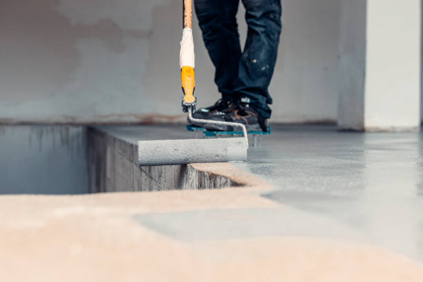 istock A construction worker apply grey epoxy resin in an industrial hall 1427527764