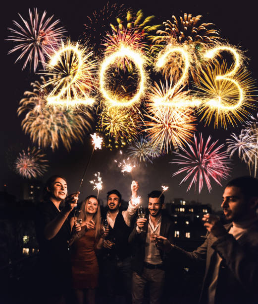 celebrating the new year's eve friends celebrate the christmas on the rooftop 2023 photos stock pictures, royalty-free photos & images