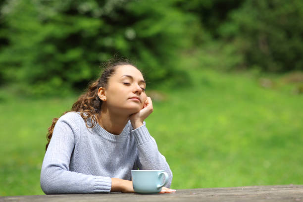 istock Woman in a park drinking and relaxing 1427530559