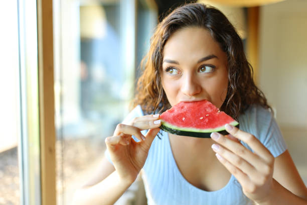 istock Woman in a restaurant eating watermelon 1427530571