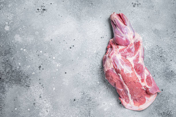 istock Raw lamb shoulder meat on butcher table. Gray background. Top view. Copy space 1427532060