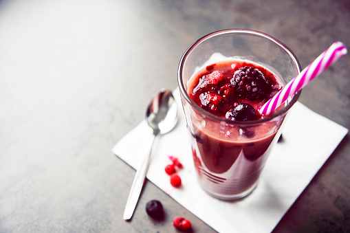A tasty smoothie with fruits in a glass