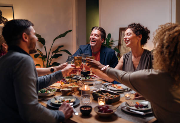 istock Friends Toasting With A Glass Of Wine During A Dinner Celebration 1427534717