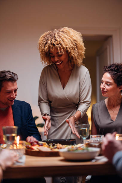 istock Multi-Ethic Group Of Friends Having Fun At Dinner Table 1427534735