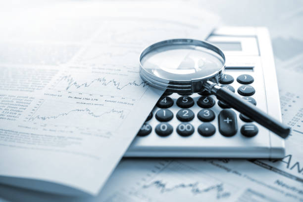 istock Calculator magnifying glass and charts 1427537698