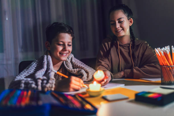 istock Boy and girl studying with a burning candle. 1427538341