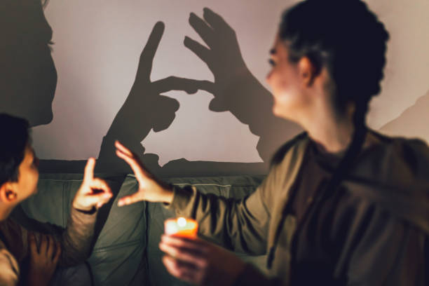 istock Brother and sister playing with shadows at home. 1427539093