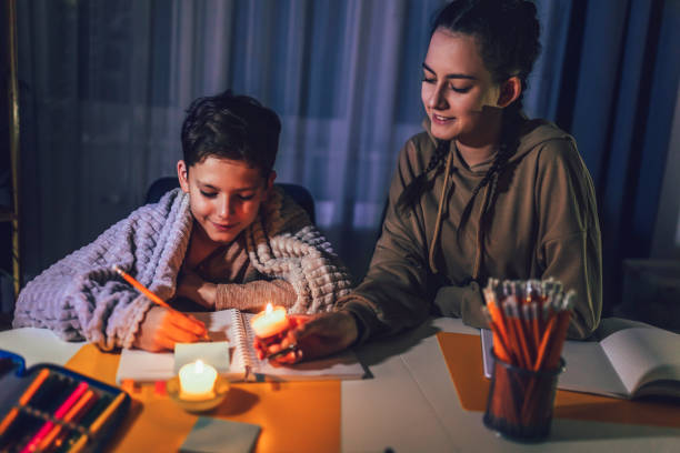 istock Boy and girl studying with a burning candle. 1427539116