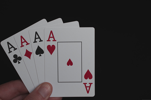 Playing cards four aces on a black background