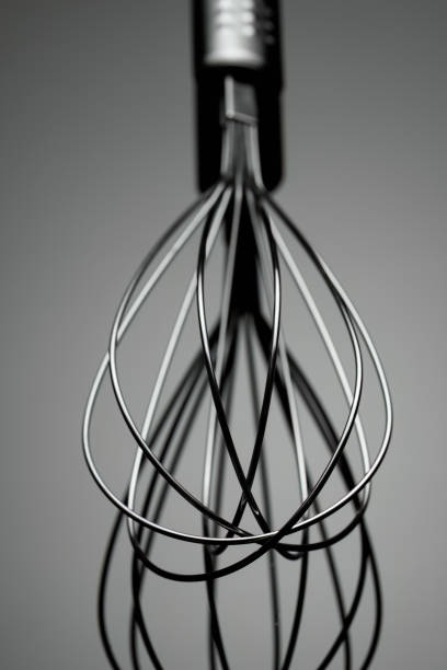istock stainless whisk isolated on dark background 1427539820