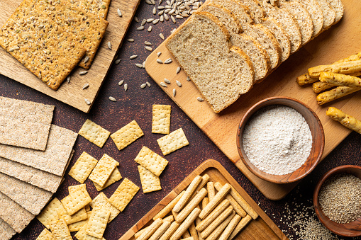 Healthy lifestyle. Wholegrain bread with gluten free grains on wooden background, copy space