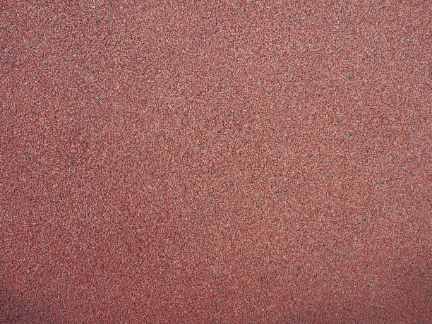istock red pebbles texture background. park or playground flooring material 1427541483