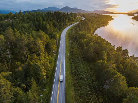 istock Scenic aerial view of truck on the road near the lake in Norway 1427542581