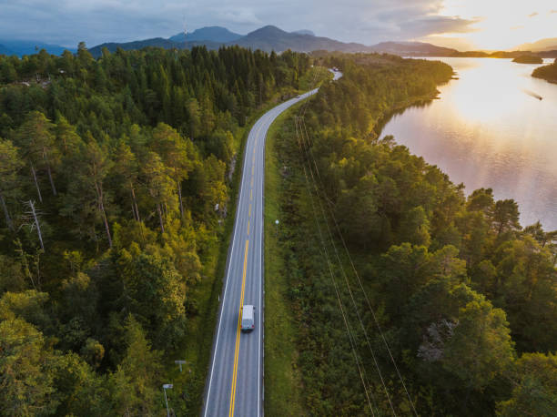 Scenic aerial view of truck on the road near the lake in Norway Scenic aerial view of delivery truck on the road near the lake in Norway plateau concept stock pictures, royalty-free photos & images
