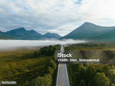 istock Scenic aerial view of road through Norwegian forest 1427542591
