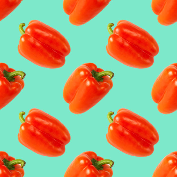 istock Pattern of fresh red peppers on a green background 1427542601