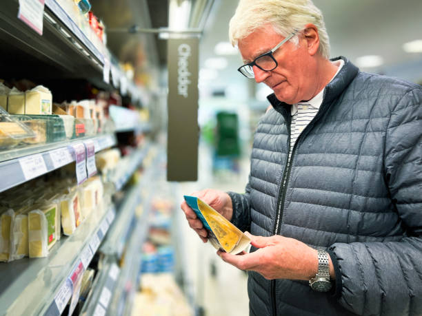istock Senior man looking at cheese in supermarket 1427542677