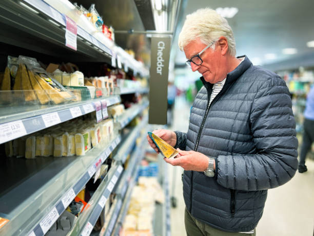 istock Senior man looking at cheese in supermarket 1427542681