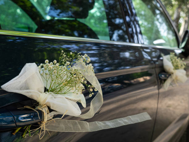 istock Wedding decoration with flowers on the white car 1427543541