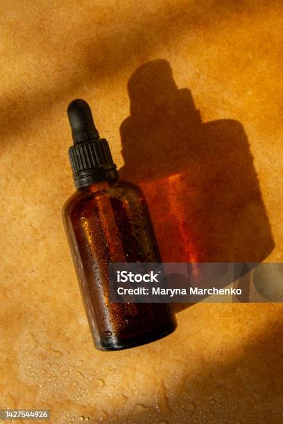 Natural Cosmetic Jar Brown Color Sunlight Cosmetics Natural Cosmetics Water Drops Pharmacy Laboratory Natural Cosmetics Stock Photo - Download Image Now