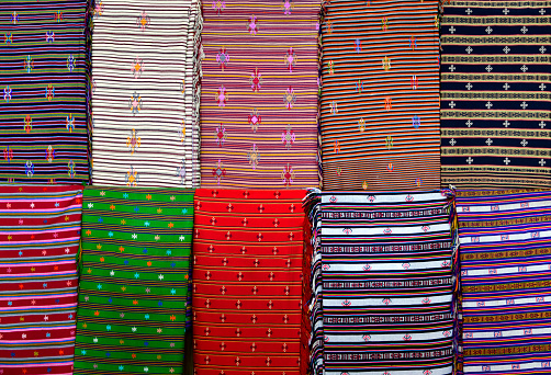 Thimphu, Bhutan: traditional Bhutanese textile pattern -  woven fabric, 'hor' technique weaving - 'Thagzo', the art of weaving is an essential part of Bhutan’s cultural heritage. Bhutan's government has made the national dress the standard to be worn during official setups (men wear Gho, women wear Kira).