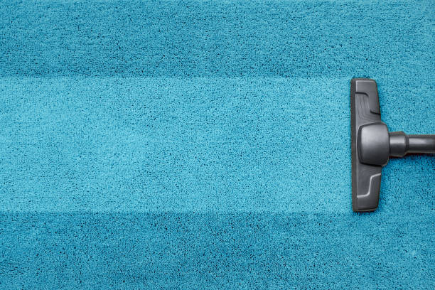 Vacuum cleaner on the blue carpet floor stock photo