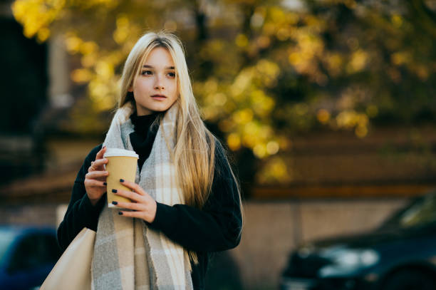 Woman wrapped in a blanket drinking hot tea