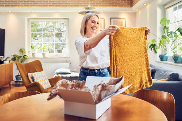 istock Mid adult woman looking on clothes ordered online 1427550154