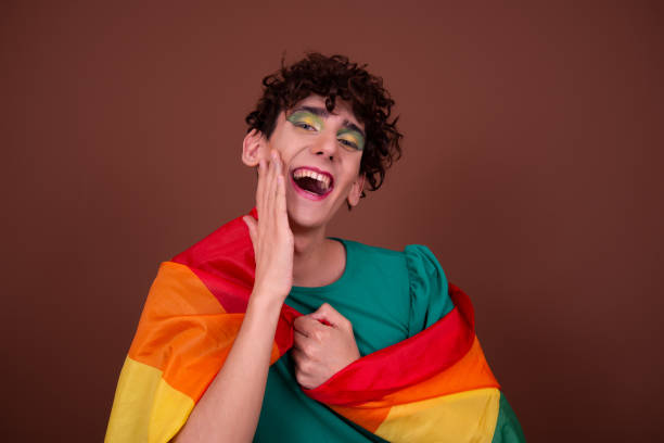 istock Young attractive guy in make-up posing in the studio. 1427552132
