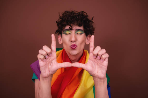 istock Young attractive guy in make-up posing in the studio. 1427552189