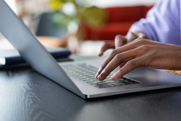 istock African man hands typing on the laptop keyboard on desk 1427553041