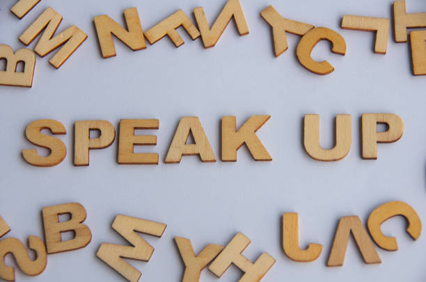 istock Speak up wooden text on while cover background. Courage concept 1427555036