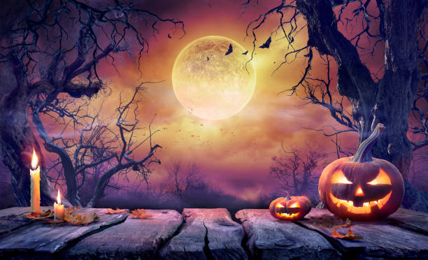 Halloween Table - Old Wooden Plank With Orange Pumpkin In Purple Landscape With Moonlight Jack O' Lantern With Candles In Violet Landscape With Full Moon halloween pumpkin jack o lantern horror stock pictures, royalty-free photos & images