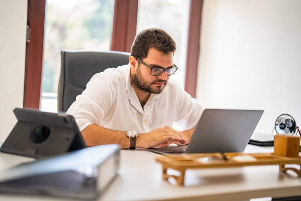 istock Young businessman working on laptop at his office 1427555276