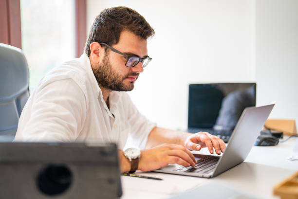 istock Young businessman working on laptop at his office 1427555397