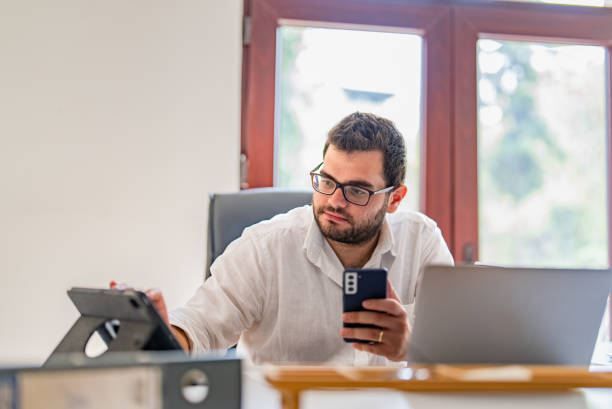 istock Businessman using digital tablet and smart phone at his office desk 1427556179