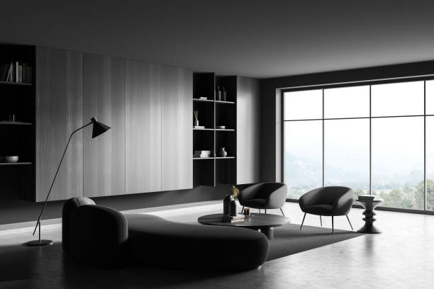 istock Grey chill room interior with couch and armchairs, coffee table. Panoramic window 1427558668