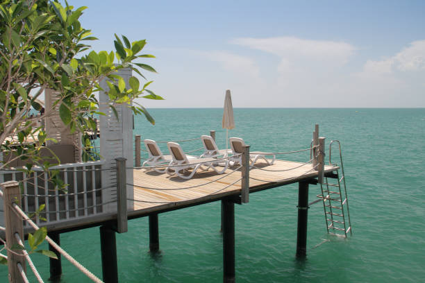 istock Paradise vacation. Empty sunbeds on the pier by the sea. 1427559165