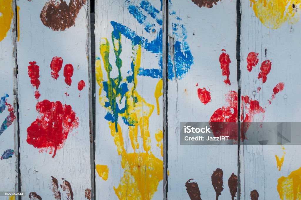 Wooden background with colored prints of children's palms Hand Stock Photo